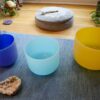 An array of Attunergy's sound bowls in a tranquil setting, each aligned to harmonize a specific chakra, embodying the essence of spiritual and emotional balance through sound therapy.