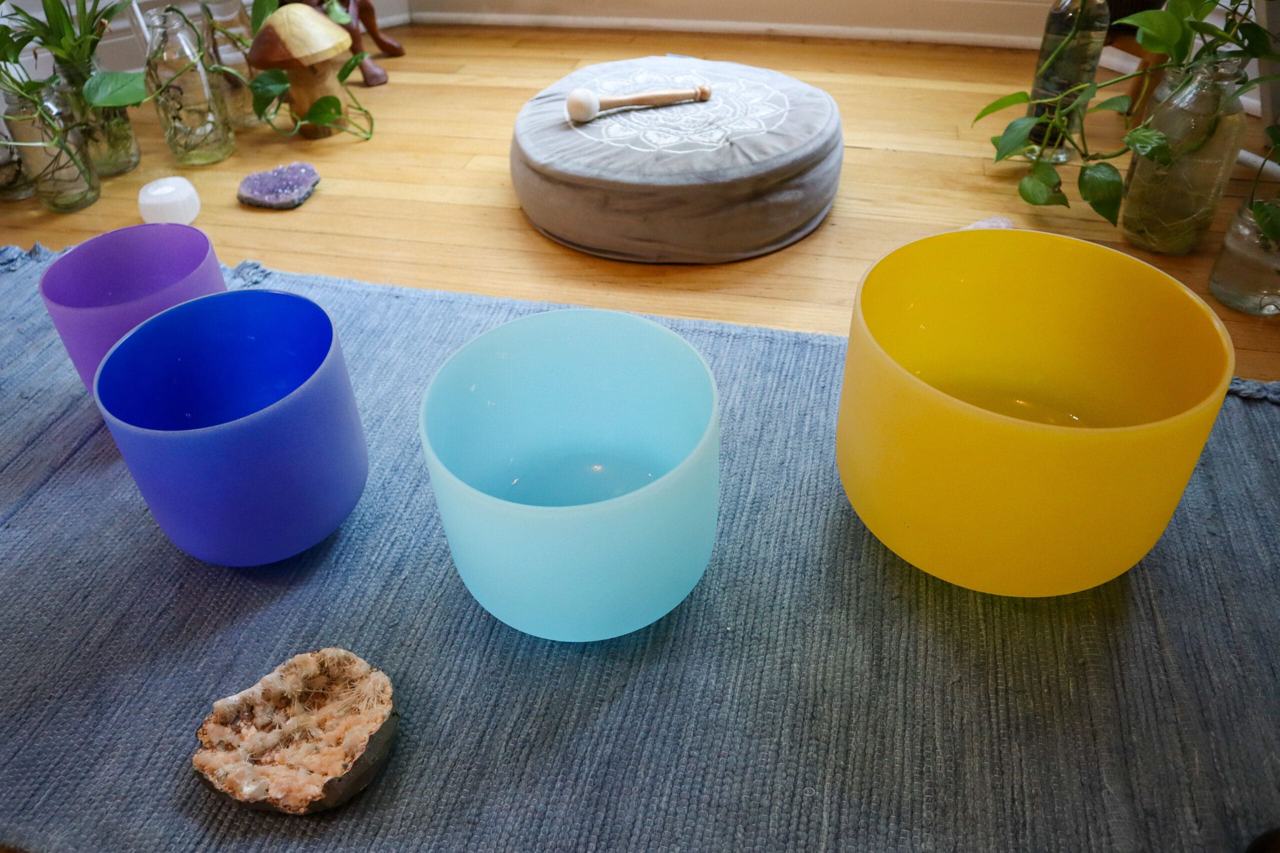 An array of Attunergy's sound bowls in a tranquil setting, each aligned to harmonize a specific chakra, embodying the essence of spiritual and emotional balance through sound therapy.