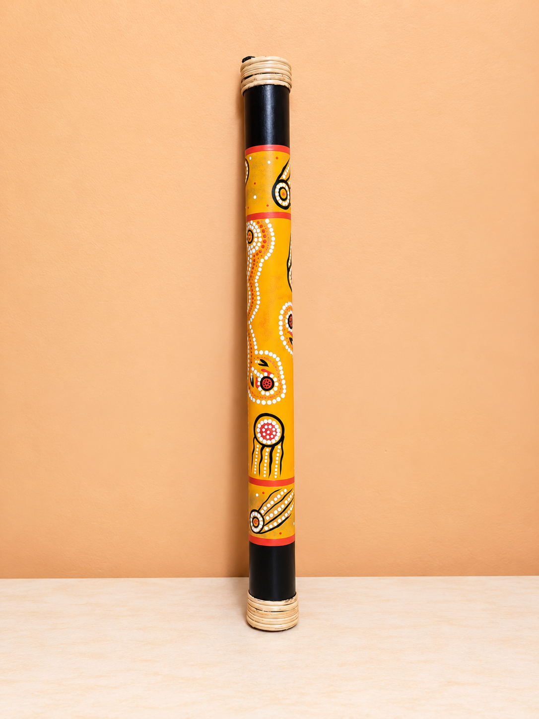 Aboriginal Dot-Art Rainstick on Peach Wall