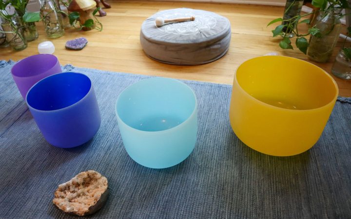 An array of Attunergy's sound bowls in a tranquil setting, each aligned to harmonize a specific chakra, embodying the essence of spiritual and emotional balance through sound therapy.